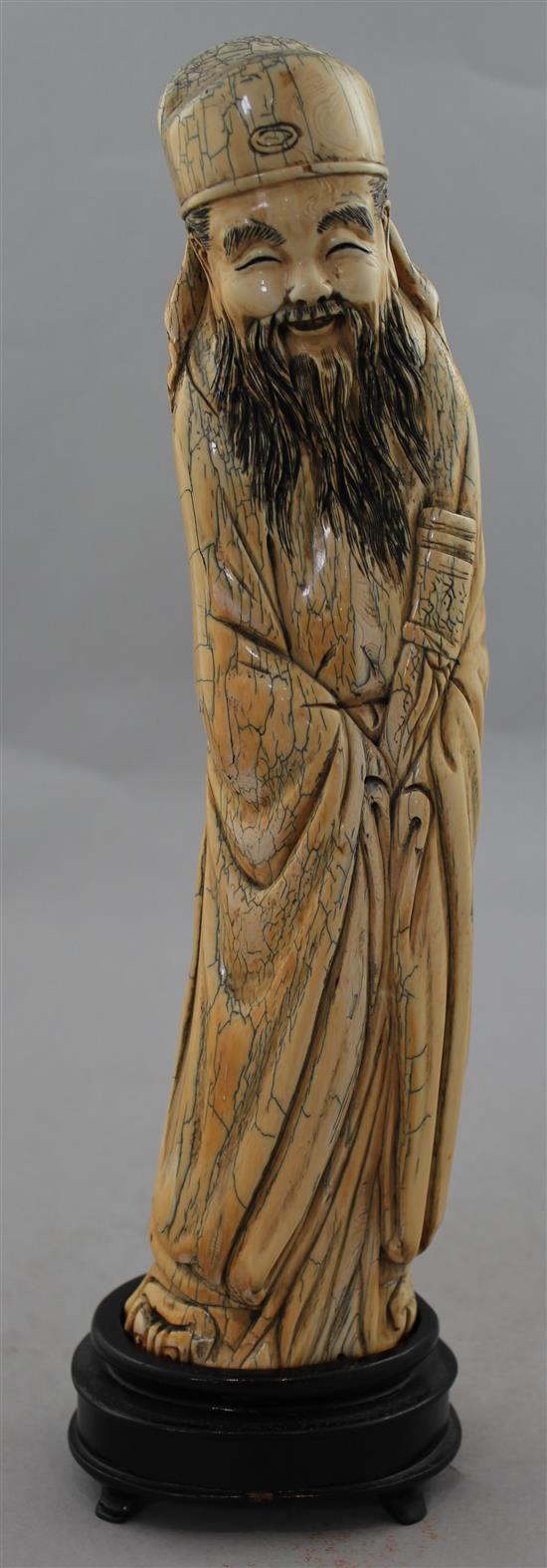 A Chinese mammoth ivory carving of an immortal, in Ming style, 20th century, 30cm, wood stand